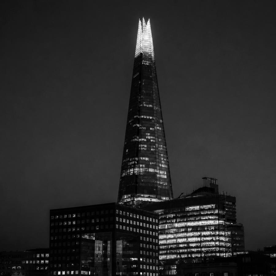 Illuminated financial-district tower at night